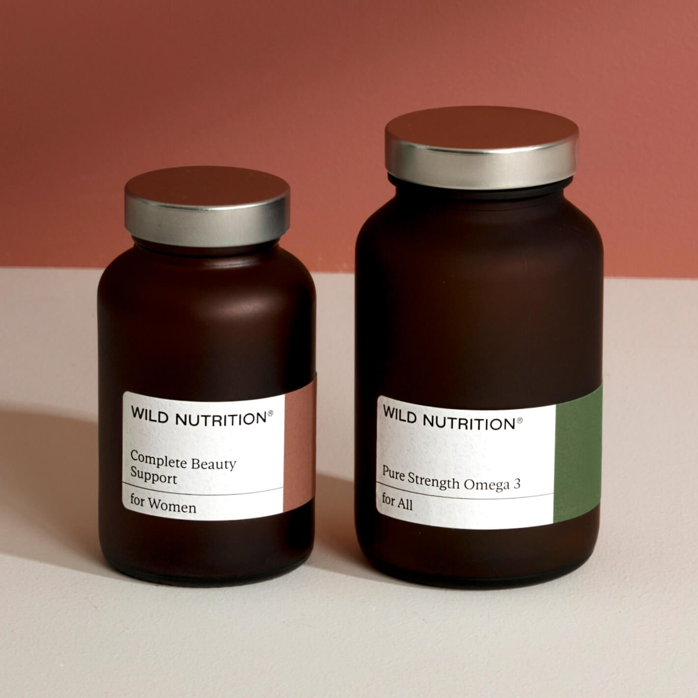 Skin Health Duo by Wild Nutrition featuring Complete Beauty Support and Pure Strength Omega 3 in elegant dark glass bottles.