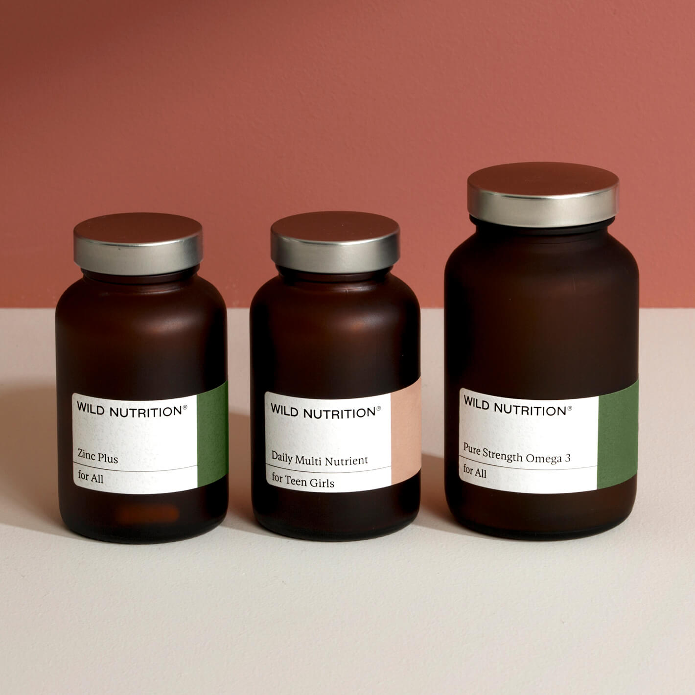 Wellness trio for teen girls featuring Zinc Plus, Daily Multi Nutrient, and Pure Strength Omega 3 in brown glass bottles.