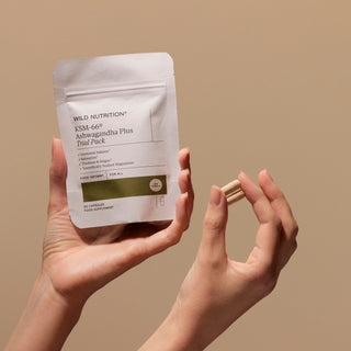 A person's hands holding a packet labeled 'Wild Nutrition KSM-66 Ashwagandha trial pack' 