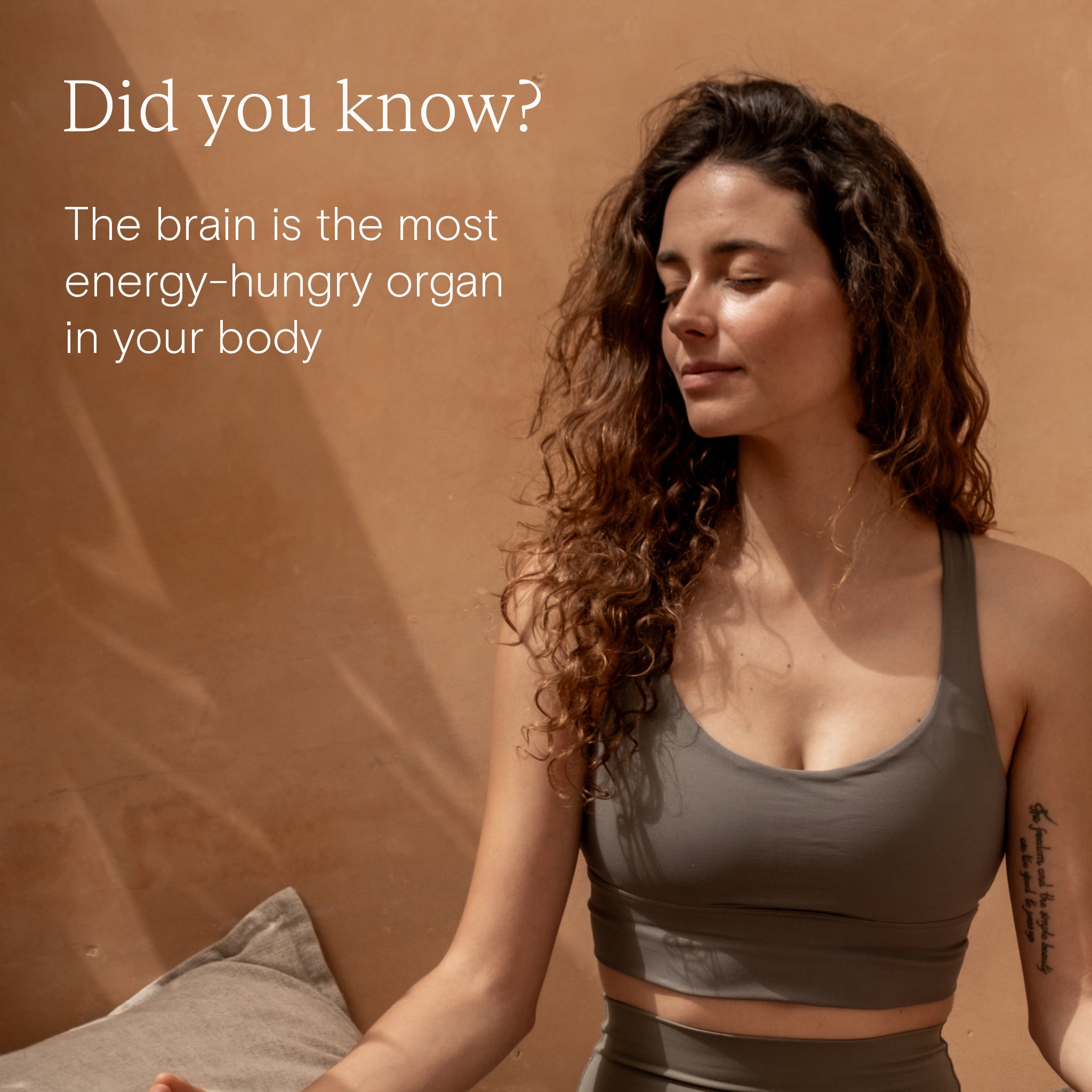Woman in a sports top promoting energy support, highlighting brain's need for energy.