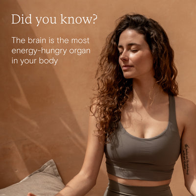 Woman in a sports top promoting energy support, highlighting brain's need for energy.