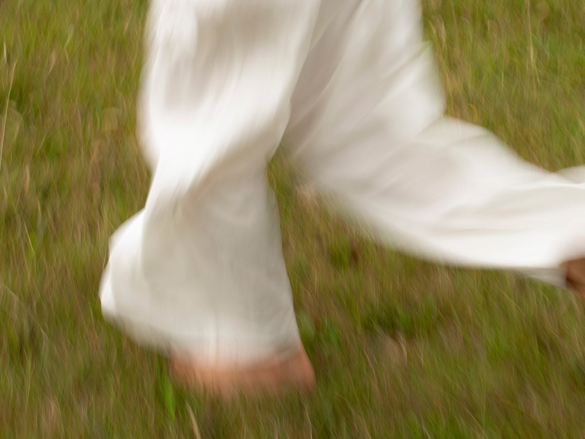 Person walking in nature symbolising mobility and wellbeing supported by turmeric supplement