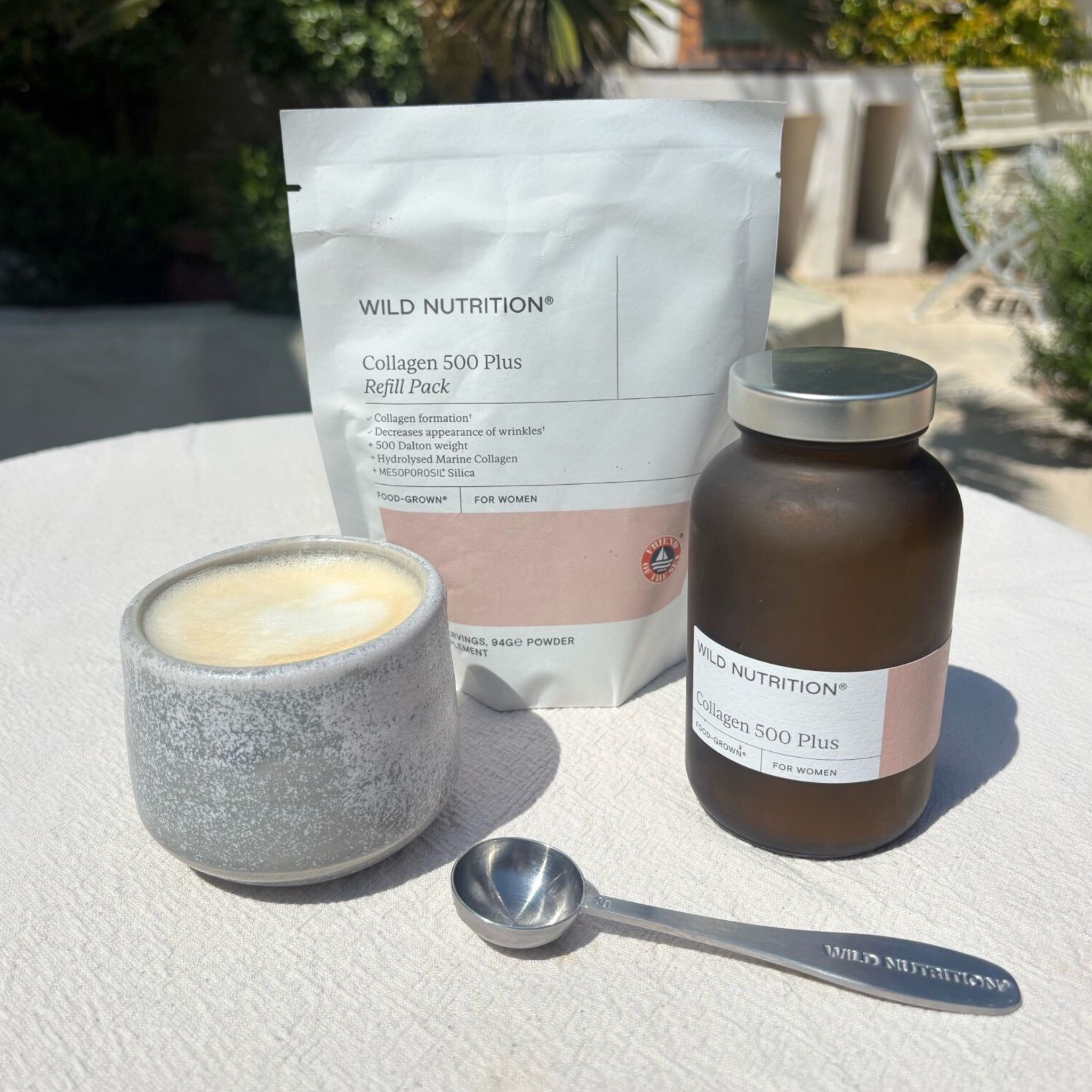 Wild Nutrition Collagen 500 Plus jar and refill pack with latte and branded scoop on outdoor table