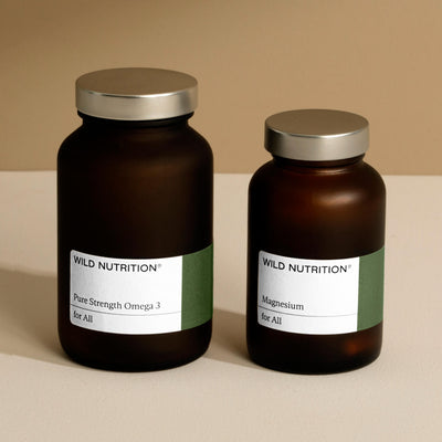 Wild Nutrition Pure Strength Omega 3 and Magnesium supplements in amber glass jars, promoting heart health.
