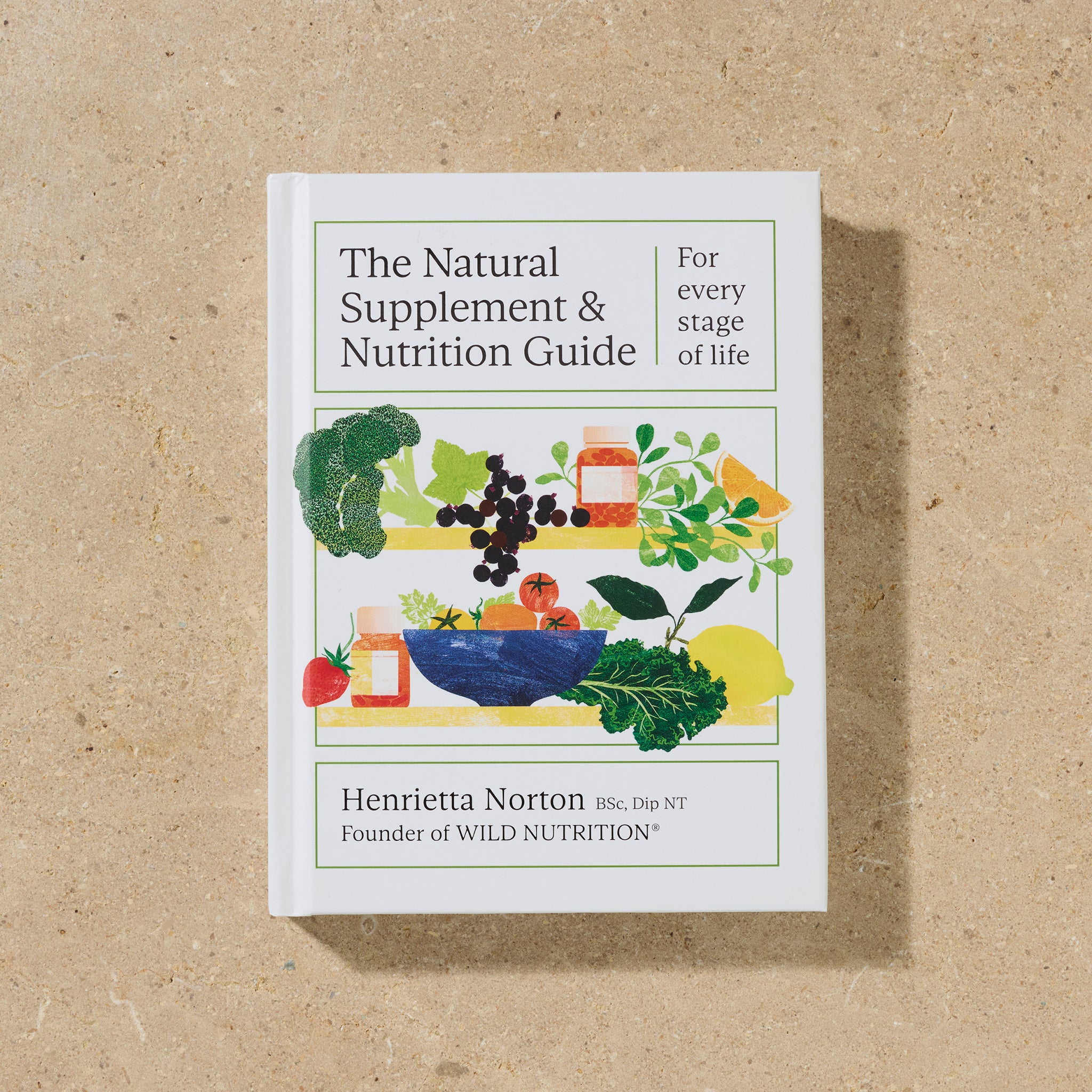 Cover of The Natural Supplement & Nutrition Guide by Henrietta Norton, founder of Wild Nutrition, photographed on natural stone background