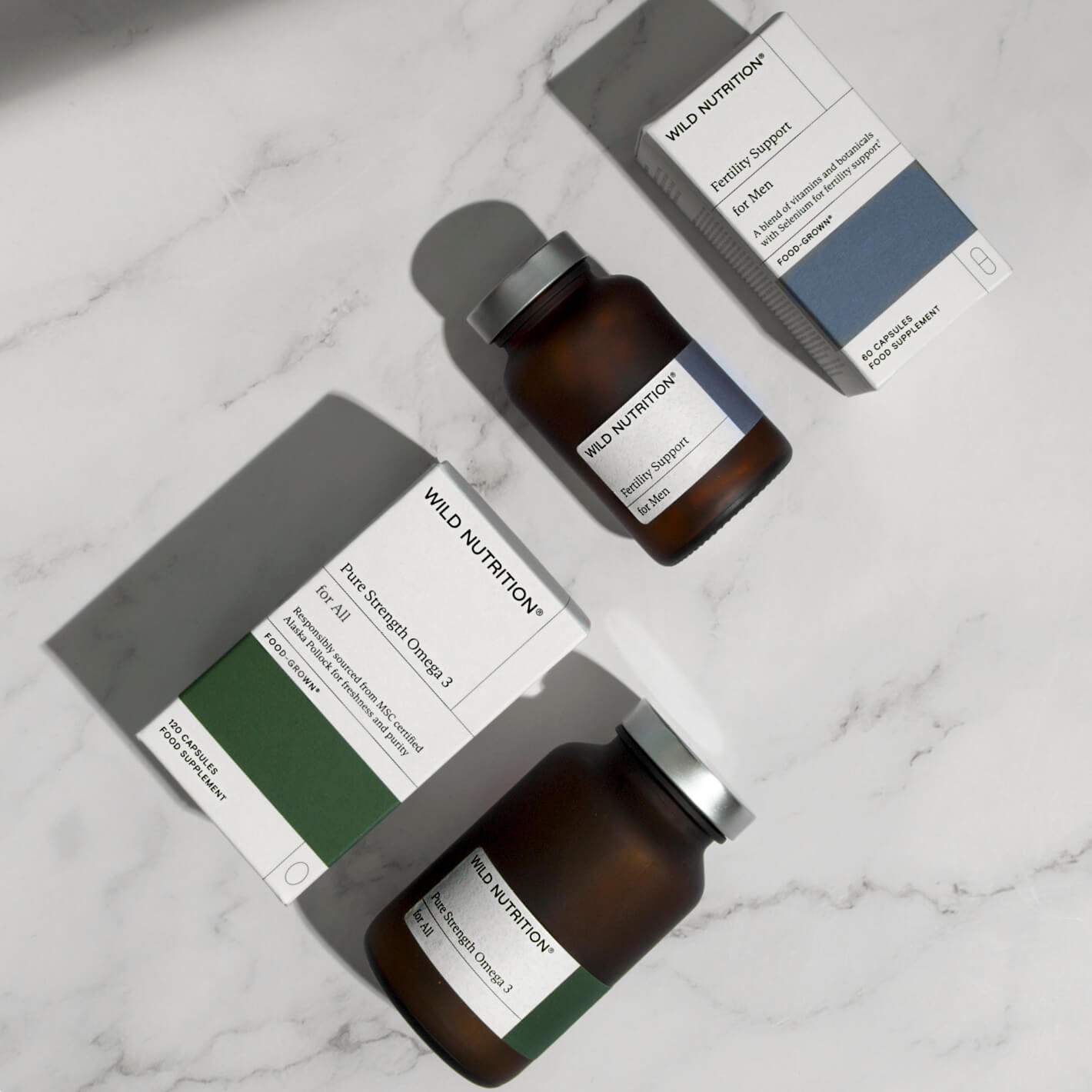 Men's Fertility Duo by Wild Nutrition for testosterone, seminal health, and immune support on a marble background.