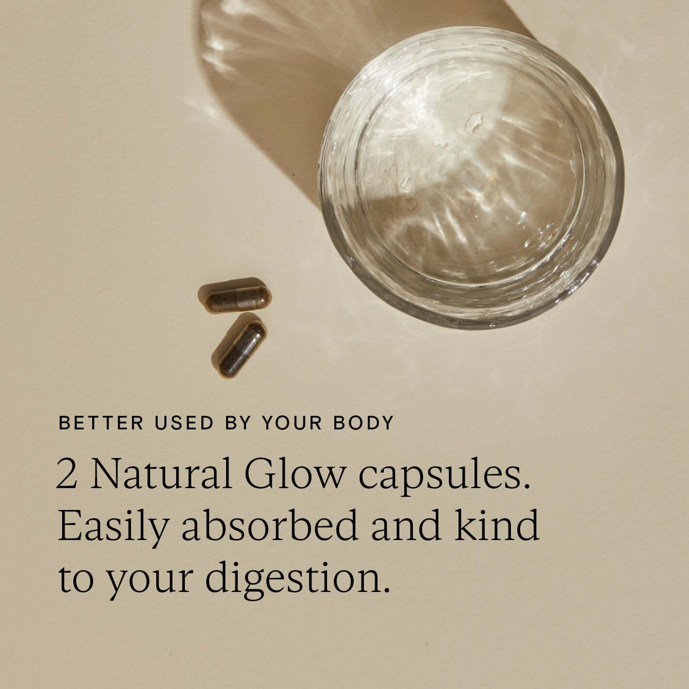 Two Food-Grown Natural Glow capsules beside a glass, highlighting easy digestion and skin benefits.