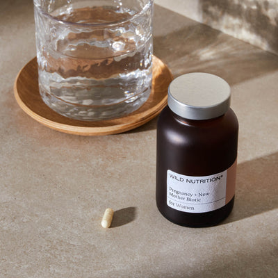 Jar of pregnancy + New Mother Biotic with a glass of water 