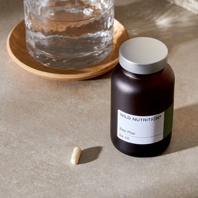 Jar of Zinc Plus with glass of water